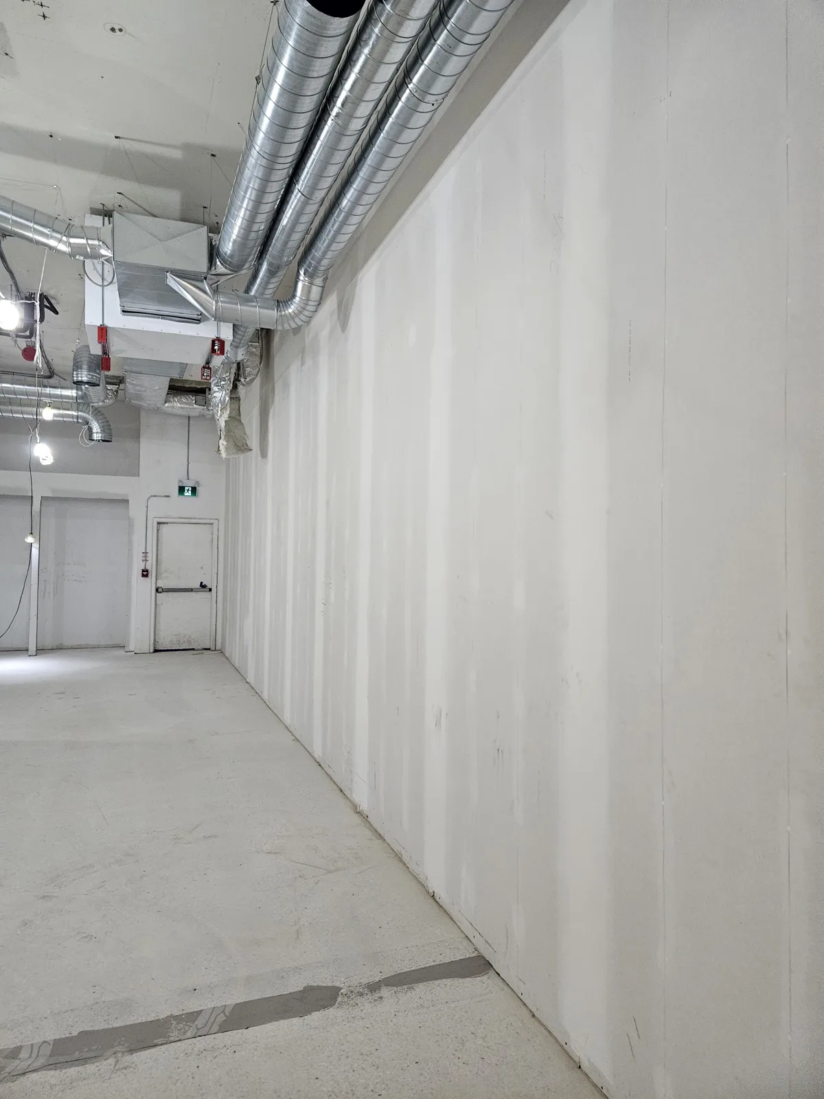Long finished commercial corridor wall built as a rated partition in Noblesville, IN