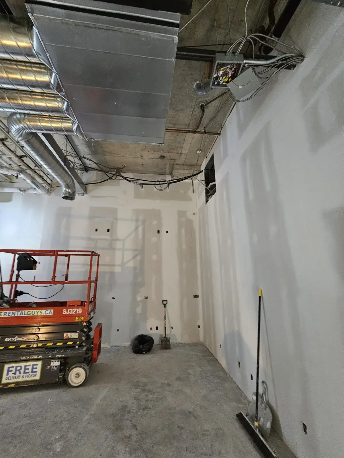 Whitestown commercial unit under construction with a scissor lift and metal framing