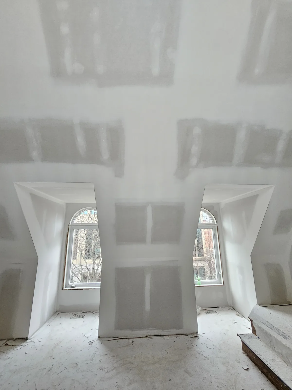 Taped and coated drywall on dormer walls and ceiling angles before sanding in a Noblesville, IN home
