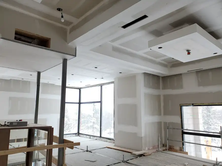 Commercial interior in Noblesville, IN with drywall bulkheads and a dropped ceiling detail under construction