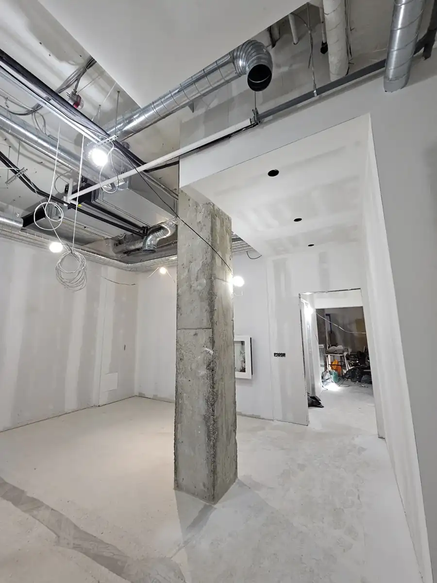 Finished commercial interior corridor with drywall columns and bulkheads in Noblesville, IN