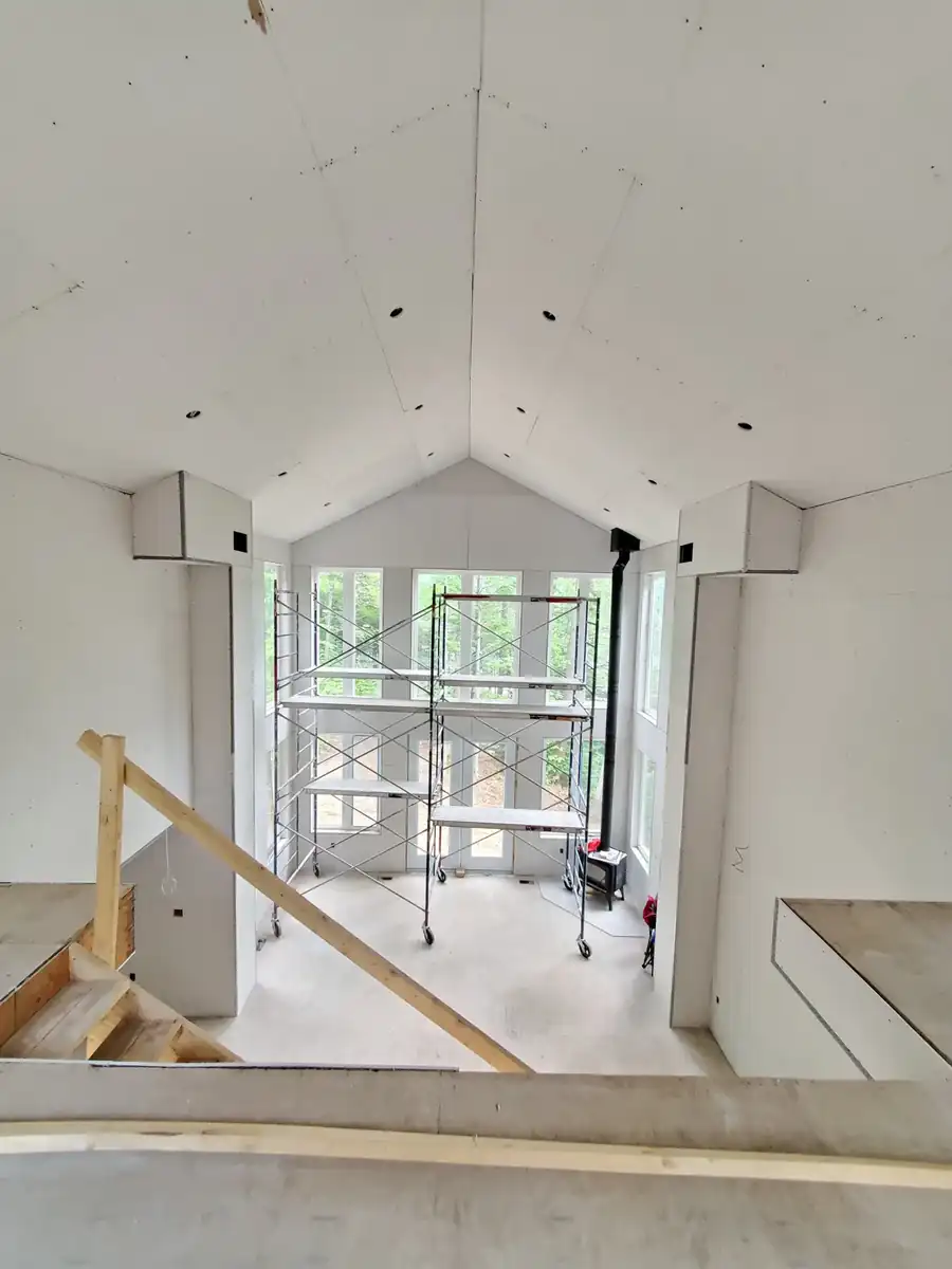 Loft and open stairwell in a Zionsville custom home with finished drywall