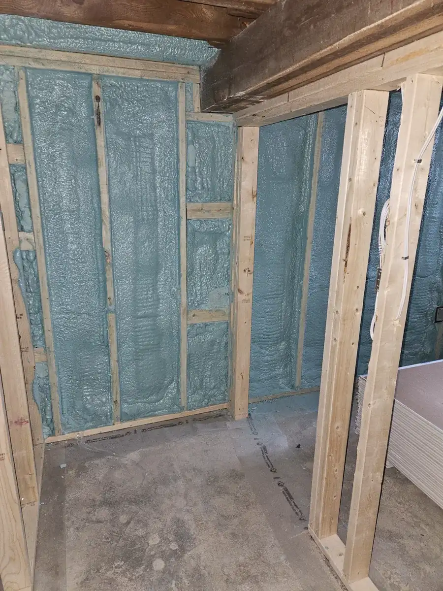 Basement stud bays and rim joist sprayed with closed cell spray foam insulation in a Noblesville, IN home