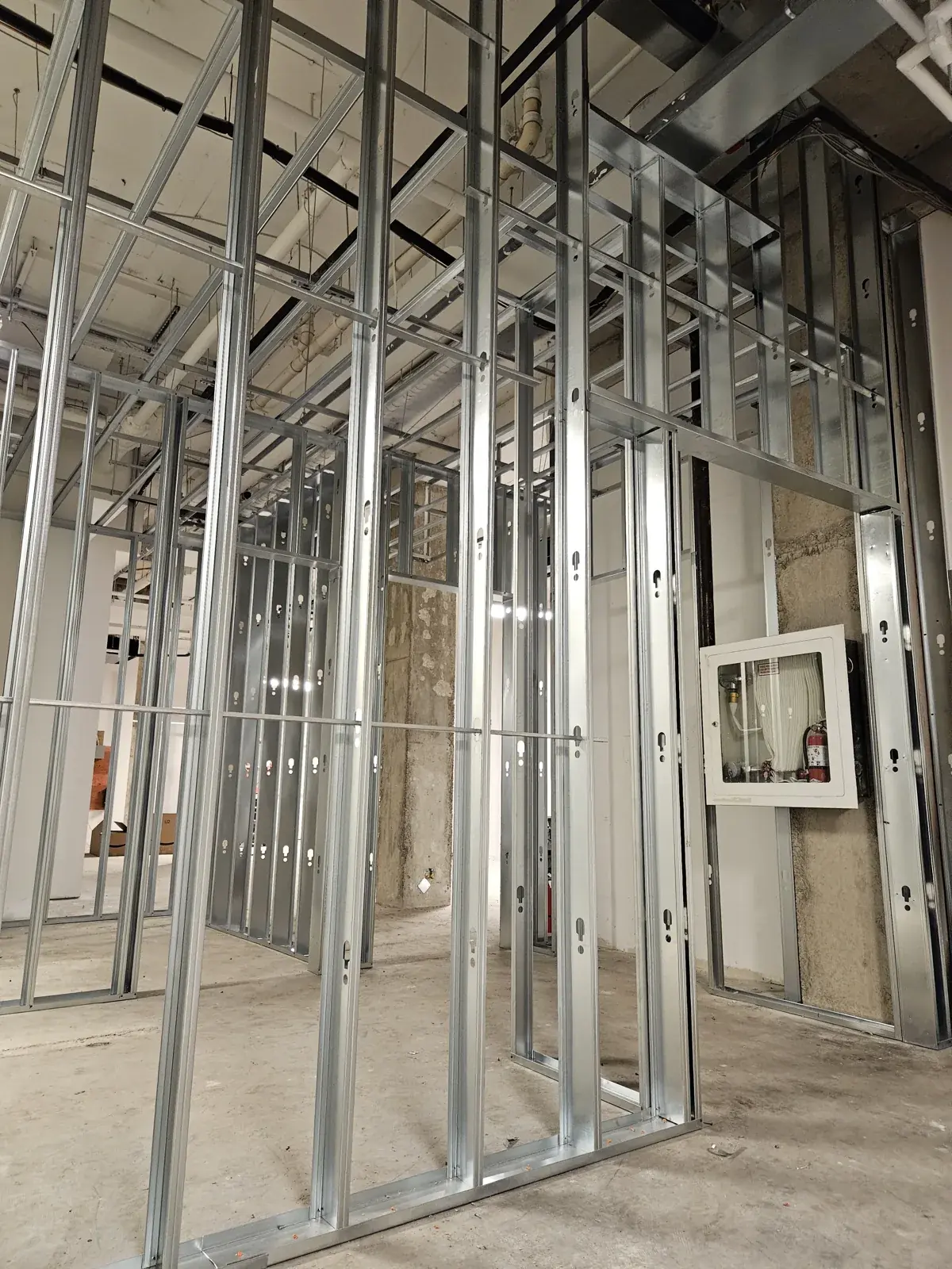 Light gauge metal stud partitions and a framed door opening in a Noblesville, IN commercial interior before drywall