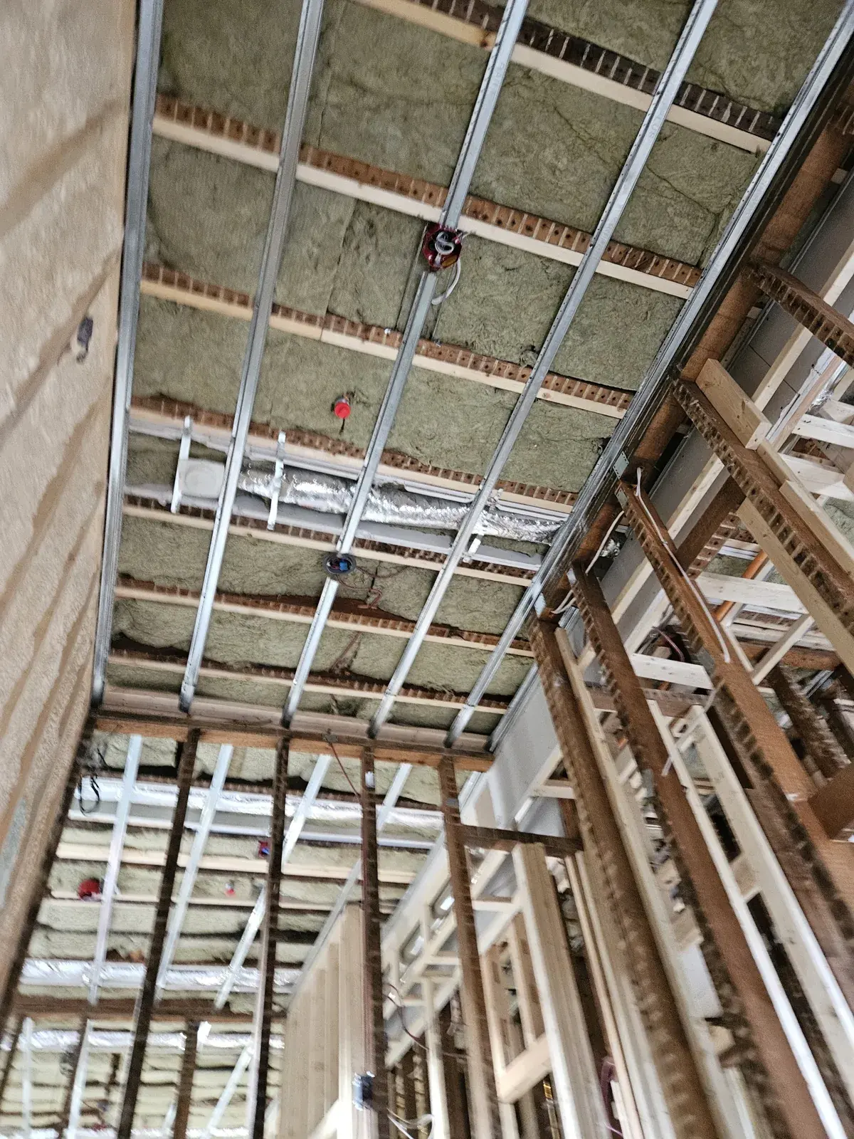 Ceiling framed with resilient metal channel over mineral wool insulation in Noblesville, IN