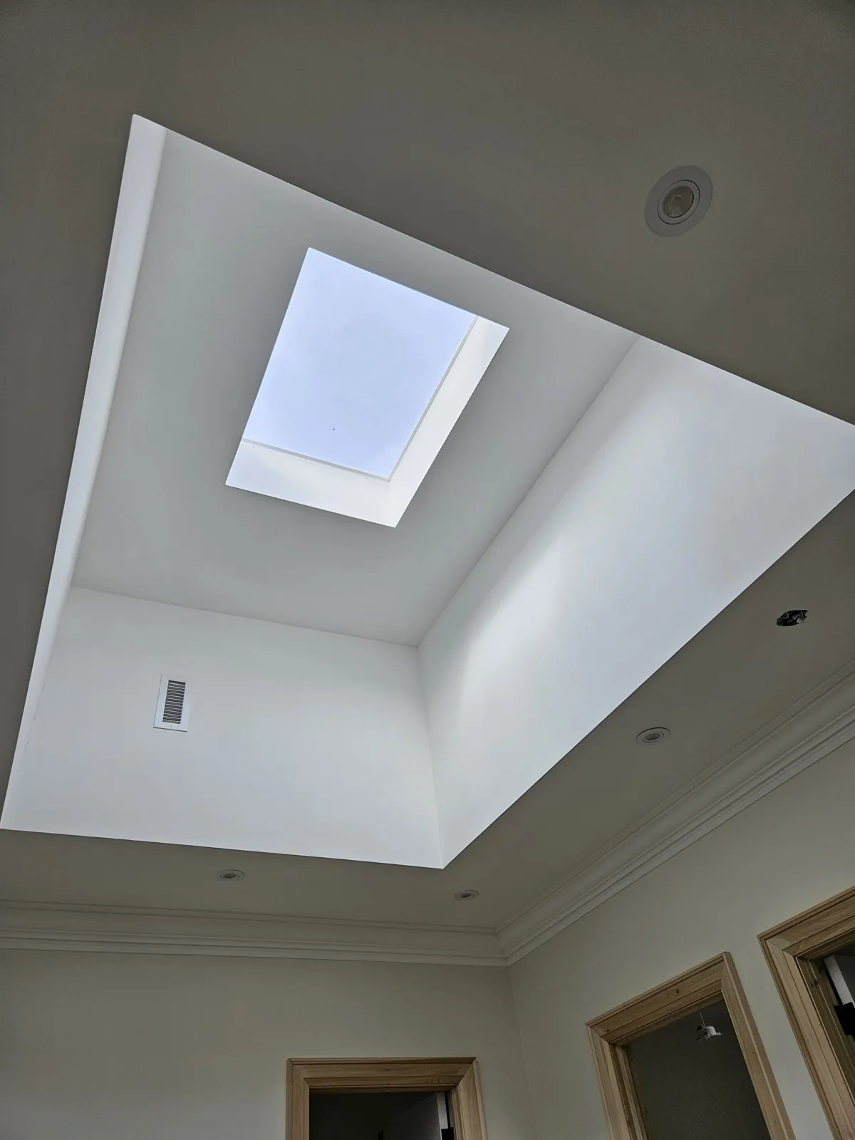 Finished tray ceiling with a skylight in a Carmel home